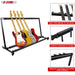 Acoustic guitar accessories and folding guitar stand, perfect for any music studio setup.